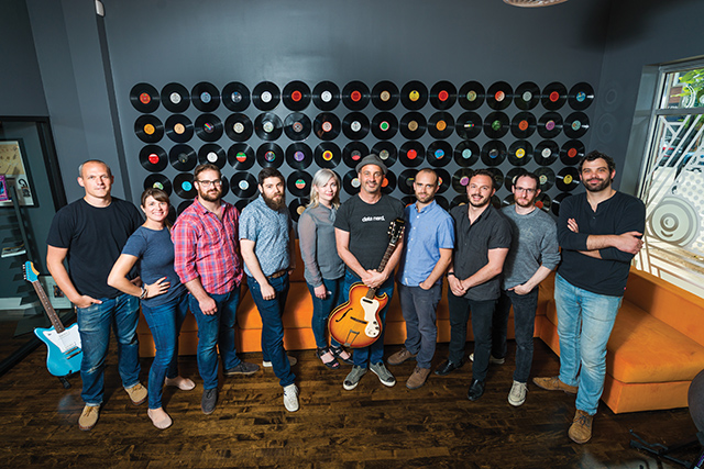 Reverb.com’s executive team shares the creativity and vision of the company’s Founder, David Kalt (at center, holding a guitar).
