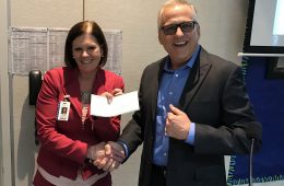 Mary Grace, Assistant Superintendent, Educational Services for Anaheim Elementary School District (AESD) receives a check for $9,000 from David Jewell, Marketing Communications Manager, Yamaha Corp. of America.