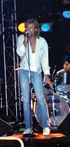 Price at the mic with his band back in the 1980s.